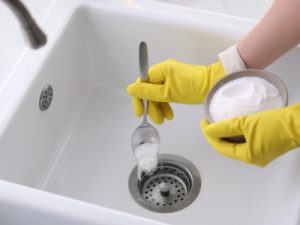 Plumber repairing leaking pipe